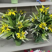 Yellow daisy and white heather cemetery bouquets