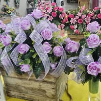 Lavender rose arrangements with sheer ribbon in wooden planters