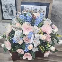 Soft pastel sympathy arrangement with blue hydrangeas and pink roses
