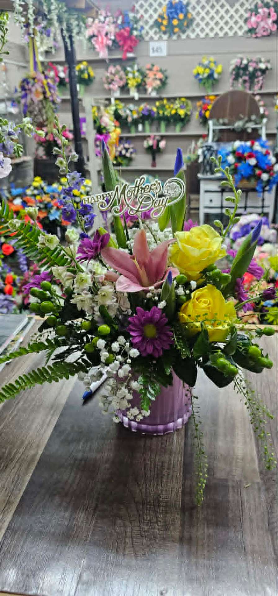 Happy Mother's Day arrangement with pink lily, yellow roses, and daisies