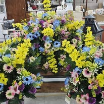 Bright spring arrangements with yellow, blue, and pink blooms