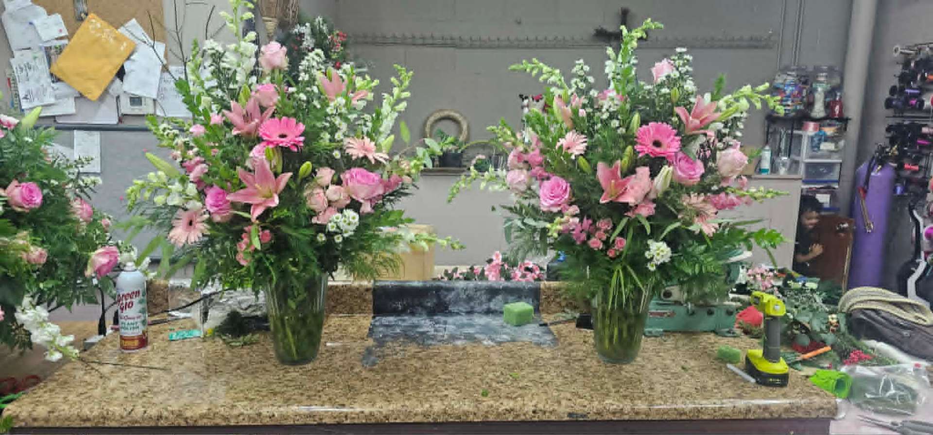 Matching pair of pink rose and lily memorial arrangements
