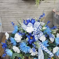 Blue and white memorial spray with delphinium and lilies